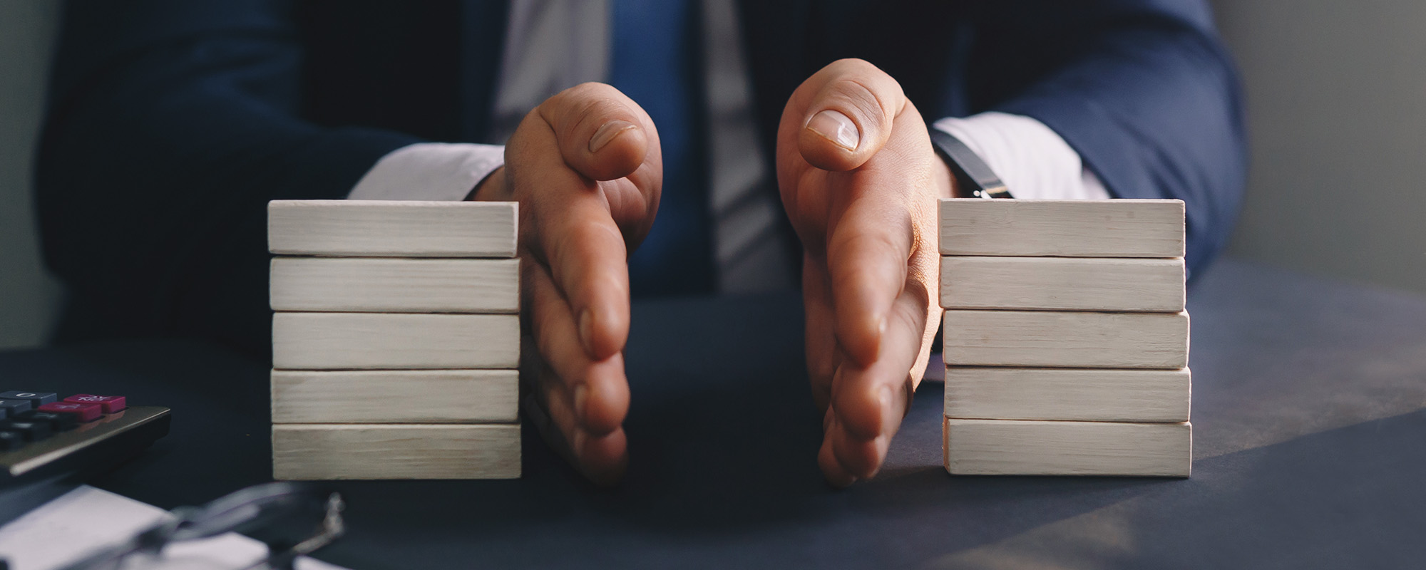 Businessman separates wooden block. Property division. Divorce and legal services. 