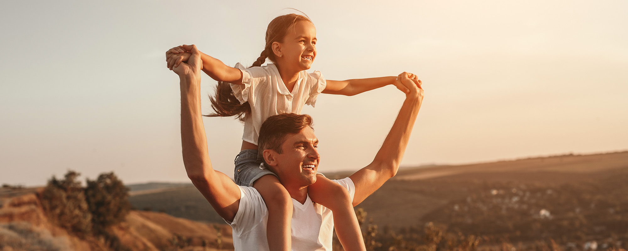 Father and daughter enjoying freedom in nature