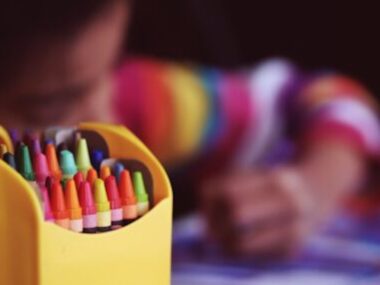 child drawing crayons