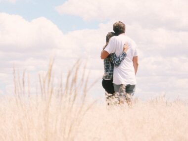 couple hugging field